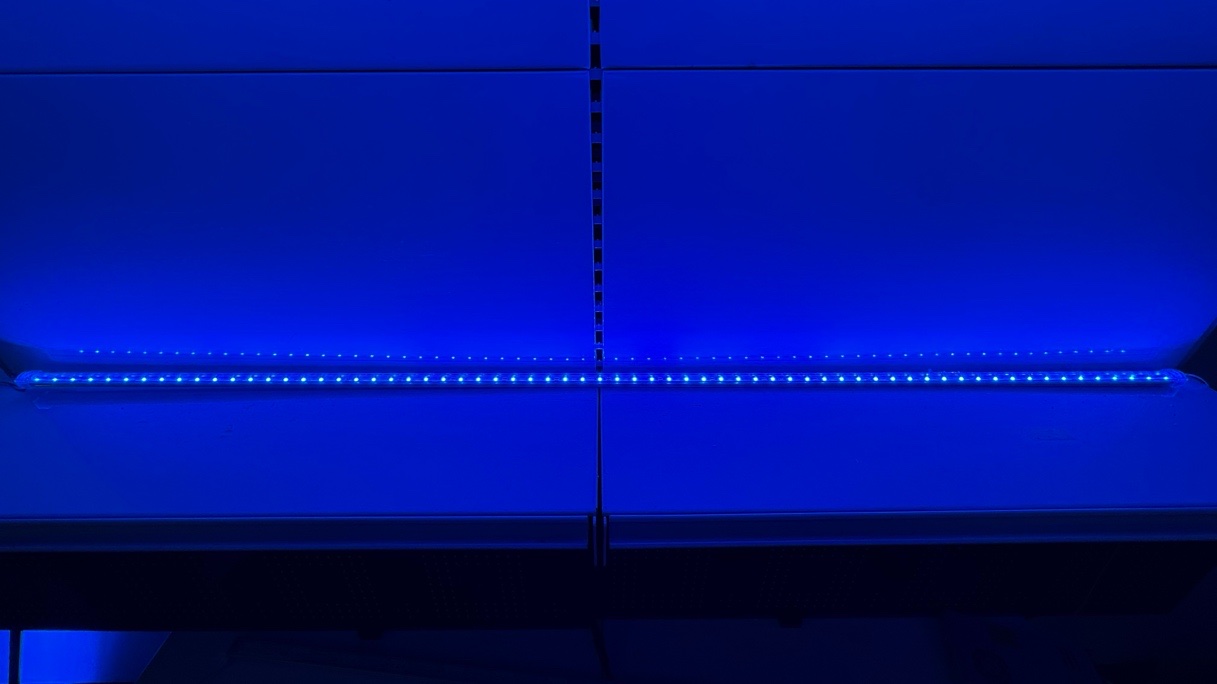 Blue edge lighting strip lit against a light panel, showing even spacing of the individual LEDs