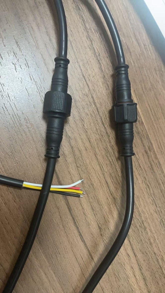 IP-rated connector pair with sealed 4-core cabling — cable seal close-up