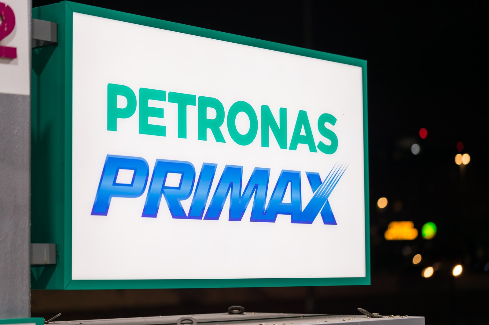 Monolith lightbox backlight lit at night — Petronas Primax panel switched by the PCU controller